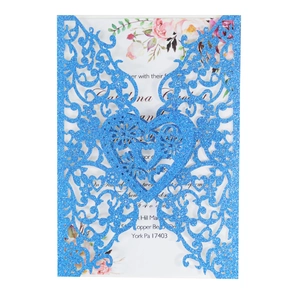 Detailed laser-cut heart pattern on blue glitter paper wedding invitation with floral insert