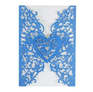 Intricate laser-cut butterfly heart pattern on glitter blue invitation sleeve detail