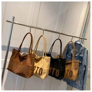 Detail of four canvas tote bags in brown, beige, black, and khaki with HOTO lettering
