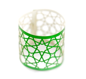 Laser-cut green paper napkin ring with hollow geometric star pattern for party decoration