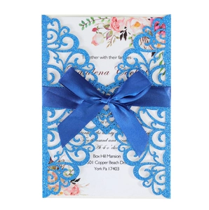Laser-cut glitter blue wedding invitation with ribbon and floral interior card