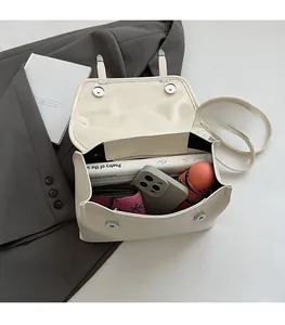 Interior view of cream vintage satchel showing large capacity for phone and wallet
