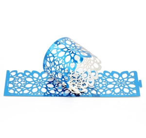 Detail of laser-cut mandala pattern on pearlescent blue paper napkin ring ornaments