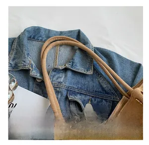 Detail of comfortable thin shoulder straps on a brown faux suede tote bag for women