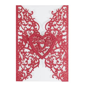 Close-up of red glitter laser-cut invitation cover with hollow heart and floral details