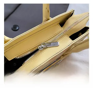 Close-up of premium silver zipper and smooth cream leather edge on this tote bag