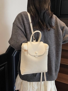 Chic cream white straw woven backpack for women featuring a leather flap and top handle