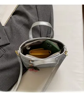 Top view of silver mini handbag showing interior storage for phone and cosmetics