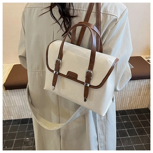 Fashionable retro cream leather backpack with brown handles shown on a model's back