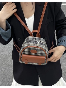 Vintage plaid mini backpack with brown leather trim shown on model in a stylish street view