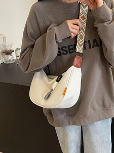White nylon crescent crossbody bag with ethnic patterned strap and leather trim