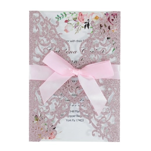 Pink glitter laser cut wedding invitation with ribbon bow and floral inner card