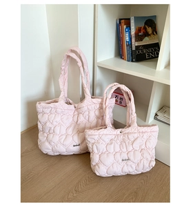 Detail of pink heart-quilted puffer tote bags in large and small set sizes