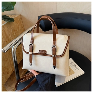 Detail view of British retro backpack in beige and brown finish on a designer chair