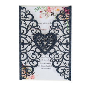 Detail of laser-cut navy blue glitter wedding invitation with heart and floral inner card