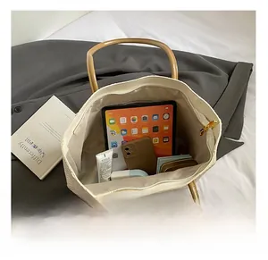 Interior view of white tote bag showing spacious capacity for tablets and daily items