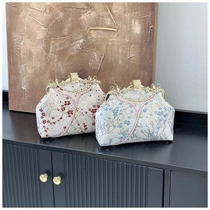 Detailed embroidery on vintage silk evening bags with crystal floral clasps and pearls