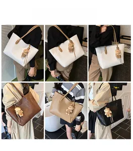 Detail showing oversized woven tote bags in four colors with cute bear charms