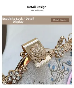 Detail of floral embroidery on grey silk with rhinestone encrusted golden flower clasp