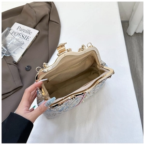 Detailed interior of vintage floral frame bag with pearl trim and zipper pocket