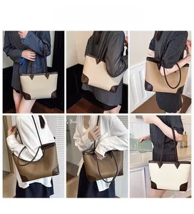 Detail showing color-block tote bag with woven straps and reinforced V-shaped leather patches
