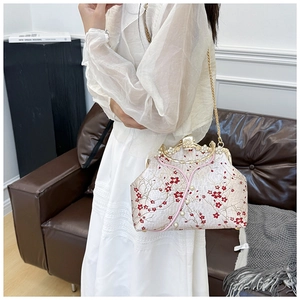 Detail of vintage floral qipao bag with plum blossom embroidery and pearl clasp