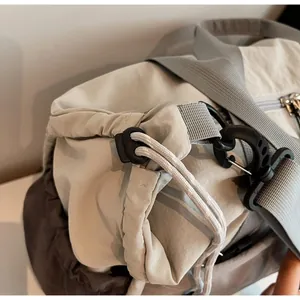Detail of durable drawstring closure and reinforced buckle on nylon travel bag