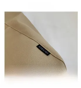 Close-up of durable canvas tote bag seams with AIMANQI brand woven label detail