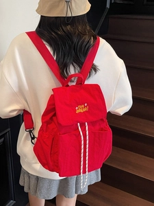 Red large capacity nylon backpack for women featuring flap and drawstring closure