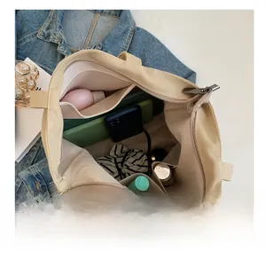 Detailed internal view of oatmeal canvas tote bag showing large capacity and inner pocket
