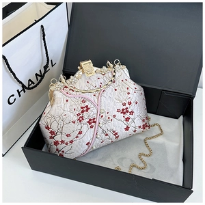 Detail of vintage cream silk clutch with red plum embroidery and pearl accents
