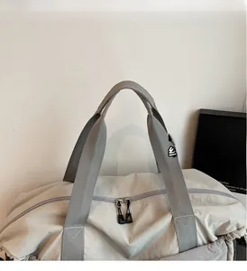 Detail of travel bag reinforced double handles and dual metal zippers with cords