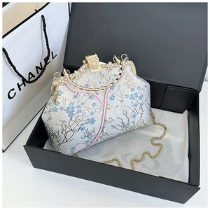 Detail of floral embroidery on ivory cheongsam bag with pearl clasp in a gift box