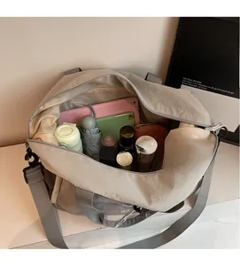 Top view of large travel bag interior showing tablet, umbrella and daily essentials