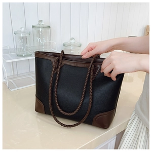 Detail showing woven handle and smooth zipper closure on lychee texture tote bag