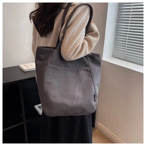 Detail of dark grey canvas tote bag showing large capacity and soft slouchy texture