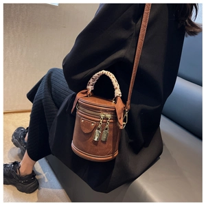Brown vintage bucket bag with leopard print scarf handle and metal lock detail