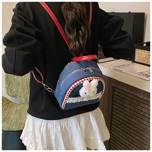 Detail showing mini denim backpack with cute 3D bunny and red checkered trim accents