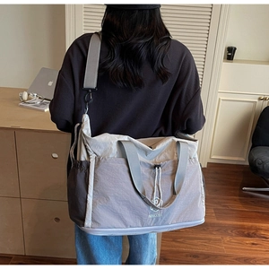 Macro detail of high-capacity travel bag with drawstring side pockets and wide straps