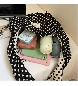 Spacious interior of black and white polka dot canvas tote bag showing high storage capacity
