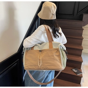 Detail of multi-color large travel bag with NINGJIA logo and textured nylon fabric