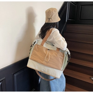 Detail of expandable large travel tote bag with NINGJIA logo and adjustable straps