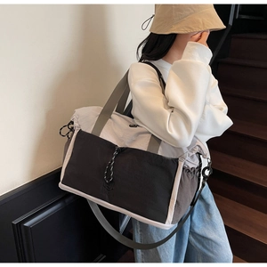 Travel bag lifestyle shot showing the tricolor expandable design with shoulder strap