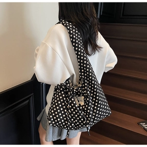 Detailed close-up of large polka dot tote bag featuring a decorative drawstring bow