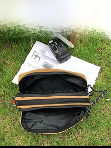 Detail showing the internal capacity and spacious dual compartments of the nylon crossbody bag