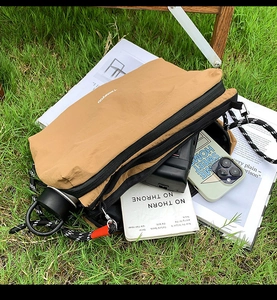 Detailed interior of nylon crossbody bag showing large capacity and multi-layer storage
