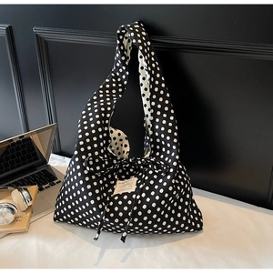 Polka dot canvas tote bag shown in daily commute setting with laptop and headphones