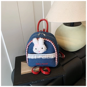 Detail of mini denim backpack with plush bunny and red embroidered letters