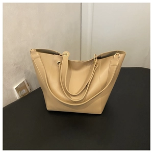 Close-up of khaki tote bag with premium leather texture and elegant gold metal hardware
