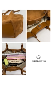 Detail view of large tote bag interior capacity with magnetic closure and contrast texture